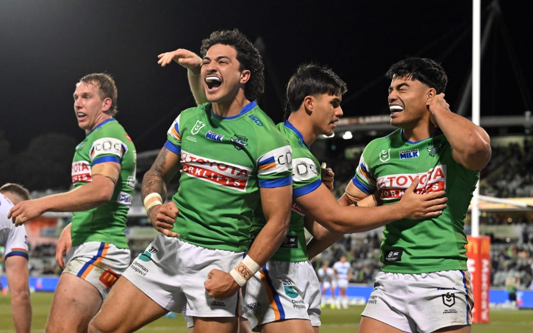 Raiders back Xavier Savage (c) celebrates after scoring a try against the Warriors.