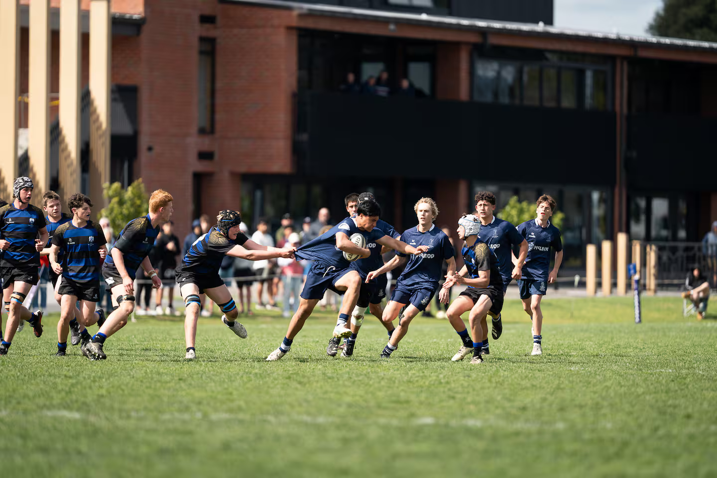 CBHS U15s (blue/black) found the going tough in the national final, going down 32-3 to Tauranga Boys' High School. Photo / Facebook